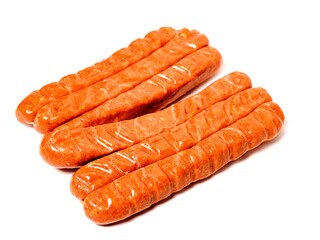 A row of top quality hot dogs are sitting on a white background. The hot dogs are covered in a brown glaze and are arranged in a neat row. Simple product made to highest standard.
