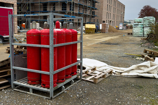 Red propane tanks and building scaffolding on construction site