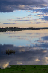 Lake Reflection of Dramatic Clouds and Sunset Sky Vertical © MiguelA