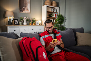Paramedic man relaxing at home checking phone