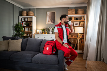 Paramedic man relaxing at home drinking coffee