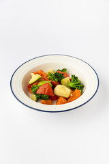 Colorful mixed vegetables in bowl, broccoli, zucchini, peppers, carrots. Healthy studio food shot