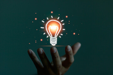 Creative idea, innovation and thinking concept. Man hand holding a light bulb icon, presenting new...