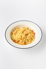 Couscous with vegetables in a white bowl, studio shot on white background