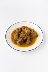Braised meat chunks in onion gravy on a plate, rustic comfort food, studio isolated