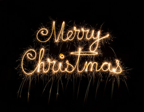Magical Golden Sparkler Light Painting of Merry Christmas in Elegant Script on Deep Black. - Powered by Adobe