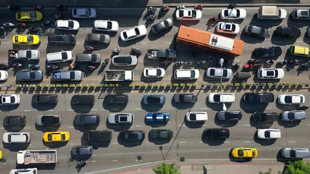 Aerial view of massive traffic jam in Bangkok, Thailand. Packed lanes of cars, buses, and motorbikes showing daily rush hour and urban life in Asia.