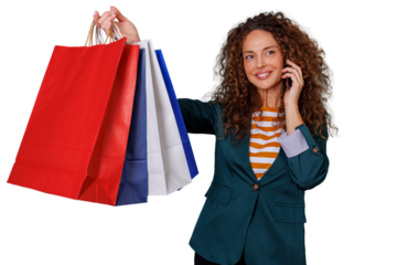 Happy woman holding colorful shopping bags and talking on mobile phone, enjoying shopping spree, transparent background