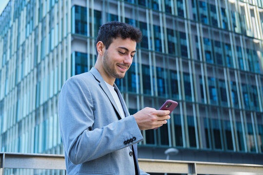 Young man using smartphone in urban business district