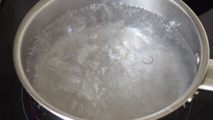 Tortellini with parmesan, ready to eat, Italian ravioli pasta with spinach and ricotta on white table, traditional italian food with herbs and vegetables