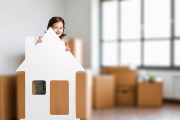 Lovely laughing little child girl playing with toy house