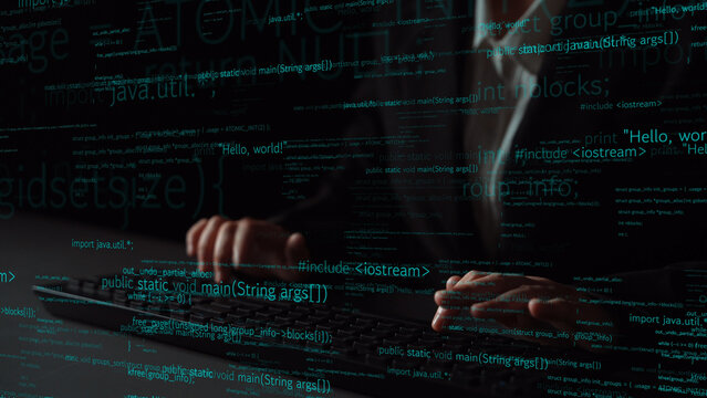 Close-up of hands typing on a keyboard surrounded by floating code snippets in a dark setting, illustrating the dynamic world of software development and technology. Xenic - Powered by Adobe