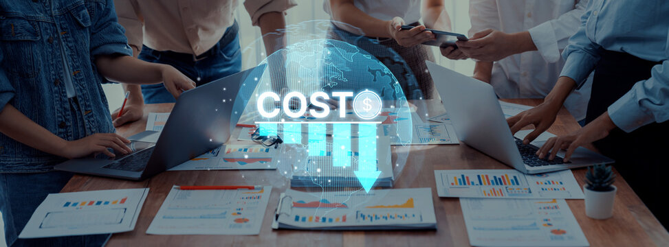 A group of professionals engages in a strategic meeting focused on business cost analysis, utilizing laptops and visual data to enhance collaboration and decision-making. Trope