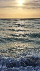 Sunset Over Ocean Waves with Golden Sky