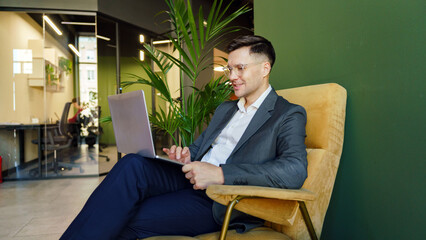 Man working on a laptop in an office setting