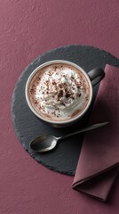 A rich, creamy cup of hot chocolate topped with whipped cream and chocolate shavings. The ultimate winter comfort drink