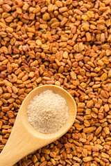 Fenugreek seeds and powder in a spoon - Methi Dana