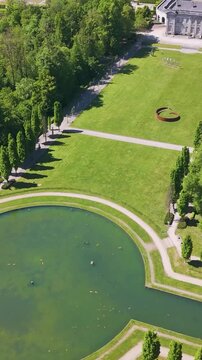 ch&acirc;teau seneffe large water filled pond complete buildings compound sun reflecting revealing backside circles aerial view of de belgium 