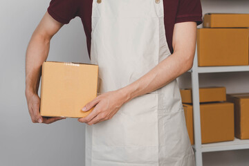 Close-up of man holding a parcel box, representing delivery service, shipping, e-commerce...