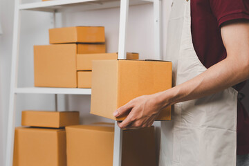 Close-up of man holding a parcel box, representing delivery service, shipping, e-commerce...