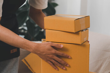 Close-up of man holding a parcel box, representing delivery service, shipping, e-commerce...
