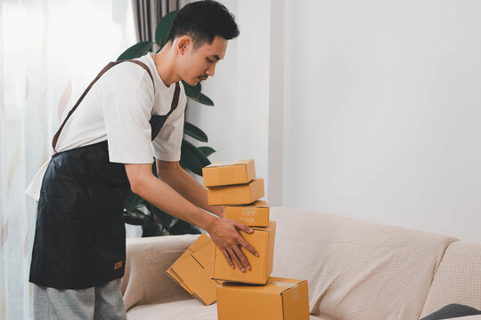 Close-up of man holding a parcel box, representing delivery service, shipping, e-commerce packaging, courier operations, and modern logistics for online customer orders.