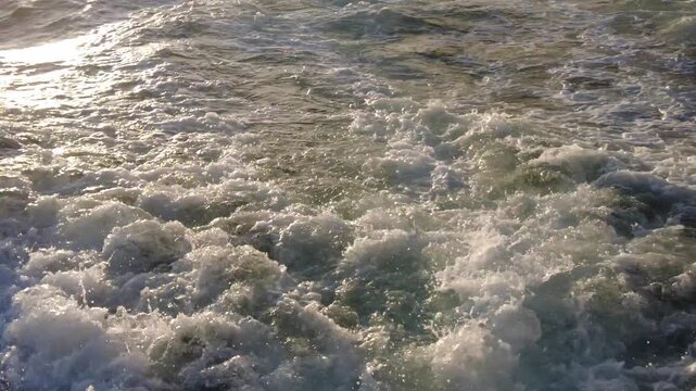 Ocean waves seen from a moving boat during sunset near Madeira Beach, Florida, U.S.A