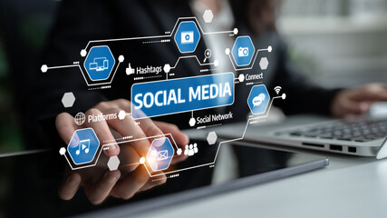 A close-up of hands using a laptop, featuring a vibrant social media interface overlay with various icons, ideal for illustrating modern digital communication and marketing strategies. Tessel