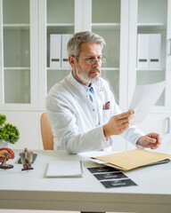 Doctor reading medical records in clinic office