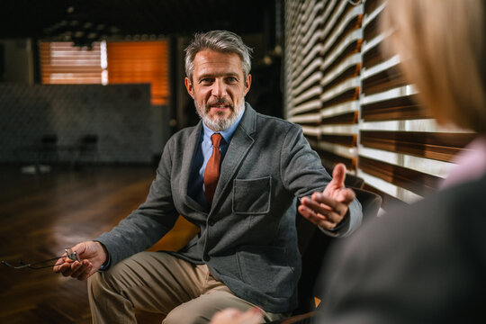 Mature businessman communicating and gesturing during informal business meeting - Powered by Adobe