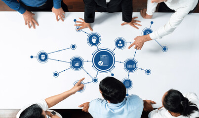 Dynamic business meeting scene with professionals analyzing digital data connections. Team focused...