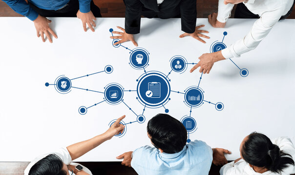 Dynamic business meeting scene with professionals analyzing digital data connections. Team focused on strategic planning at modern workspace, enhancing collaboration and communication. Amity - Powered by Adobe