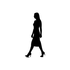 A silhouette of a woman walking in a dress and heels against a white background in a studio shot