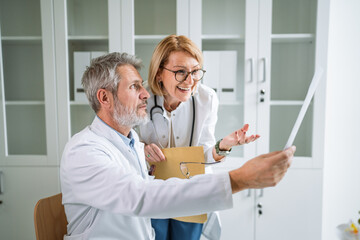 Medical team collaborating on patient report in a hospital setting