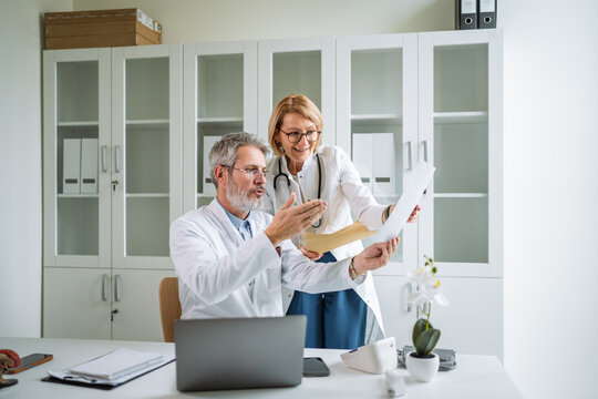 Medical team collaborating on patient report in a hospital setting - Powered by Adobe