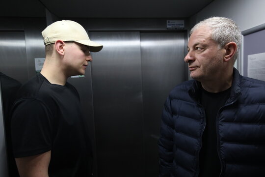 Father and teenage son in tense conversation &ndash; generational conflict, family misunderstanding, emotional communication problem