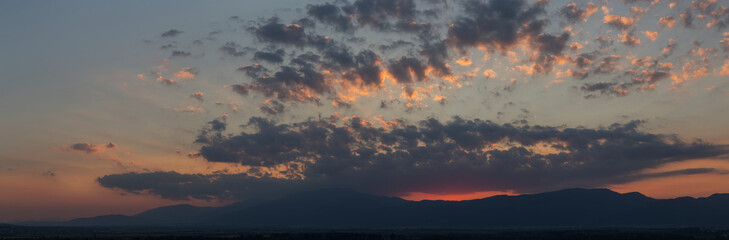 Sunset over the Balkans. The stillness and the dusk. Cirrus clouds in a crimson sky.