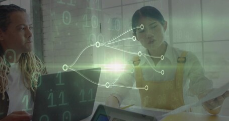 Talking team reading papers with laptop tablet pencil overlay in office, woman in yellow pinafore