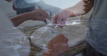 Preparing pair of hands cutting dumplings on kitchen counter with plate, utensil, coastal overlay © vectorfusionart