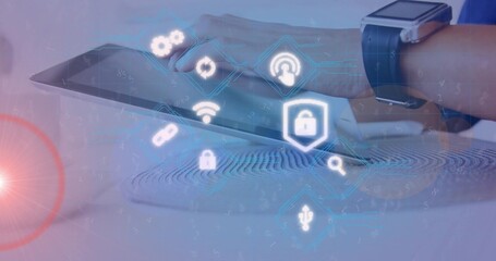 Right forearm-hand swiping tablet on desk in blue long-sleeve shirt, smartwatch showing fingerprint © vectorfusionart