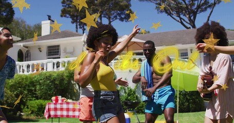 Dancing woman in yellow tank top and denim shorts moving on backyard lawn, picnic table visible