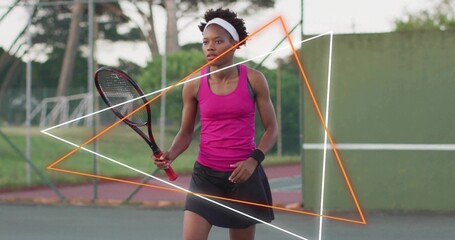 Returning tennis player in magenta top swinging red-grip racket on hard court with neon overlays