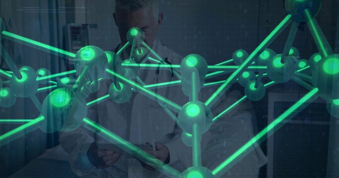 Studying senior doctor in lab coat wearing stethoscope holding tablet in exam room, green hologram - Powered by Adobe