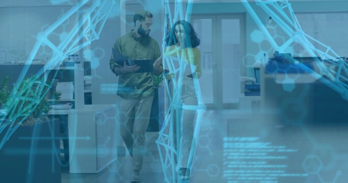 Walking pair wearing blouse, shirt gesturing at tablet holding notepad in office, hologram overlay