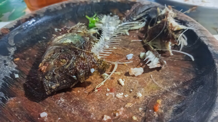 leftover of fried fish on the grill