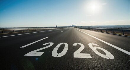 The year 2020 painted on an empty highway road stretching to the horizon. Concept of a new year, future journey, and progress forward