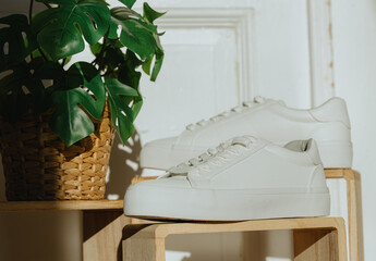 White classic sneakers on wooden boxes.