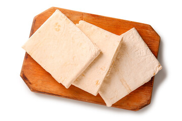 Wooden board with fresh thin lavash on white background
