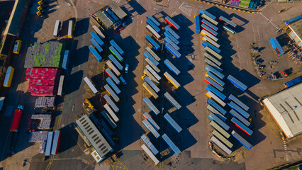 High aerial top-down view of stacked transport containers