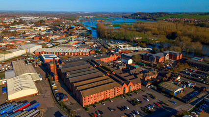 High aerial view of large red brick factory buildings